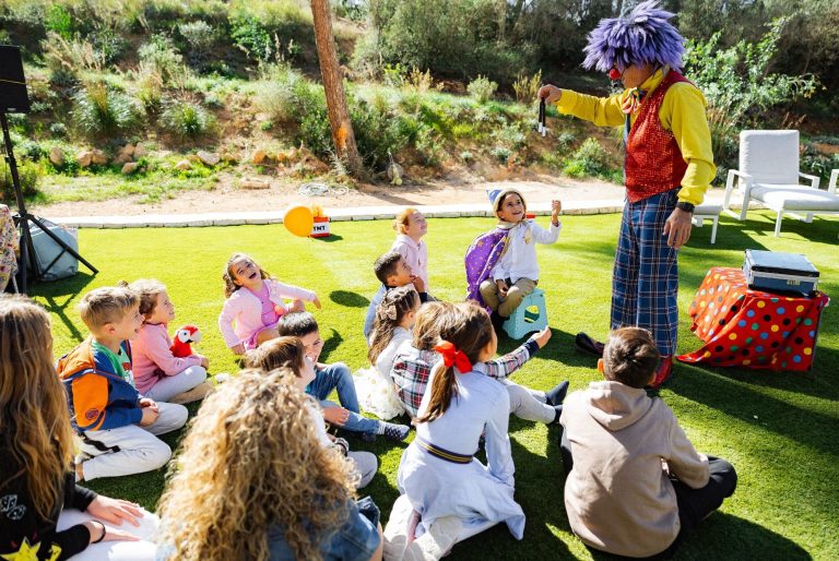 Children watching entertainment at an outdoor party in Mallorca